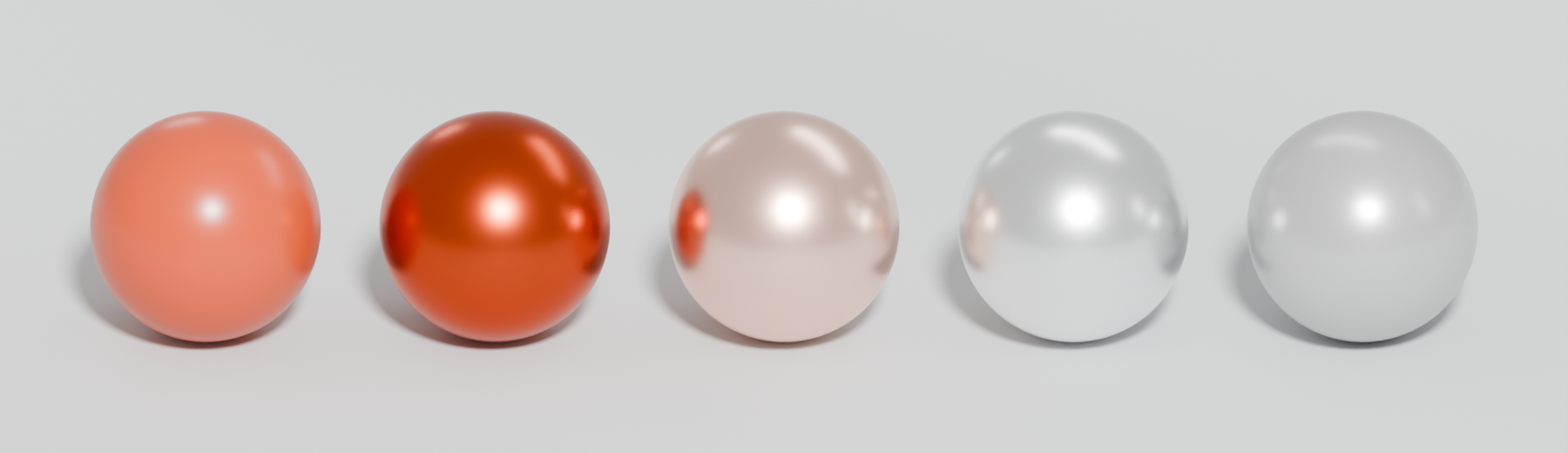 Five spheres: orange plastic, orange metal, copper-like metal, silver-like metal and a half-metallic grey.